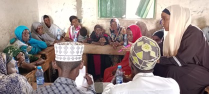 Members of the Waldaa pastoralist group sit in a room and have a discussion