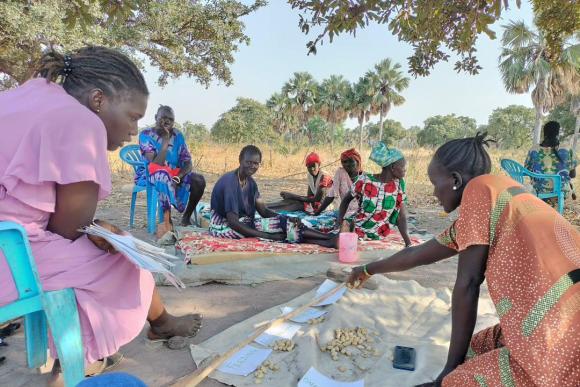 A group of women sit in a circle