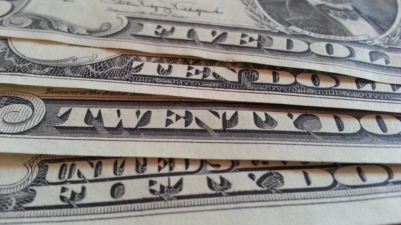 A close up of a pile of American twenty-dollar bills