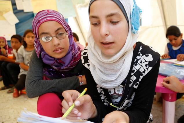 Syrian refugee children studying at a temporary school in Lebanon