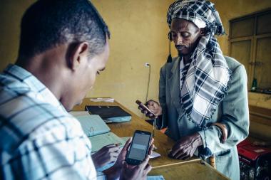Mobile phone user in Ethiopia - image by S. Sheridan / Mercy Corps